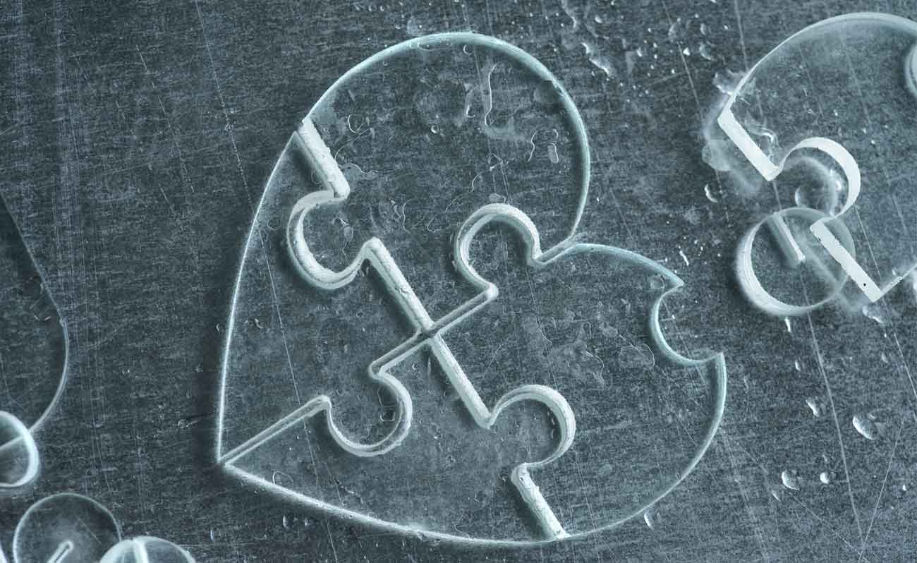 Puzzle made of glass by water jet cutting